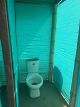 A toilet in a green tent

AI-generated content may be incorrect.